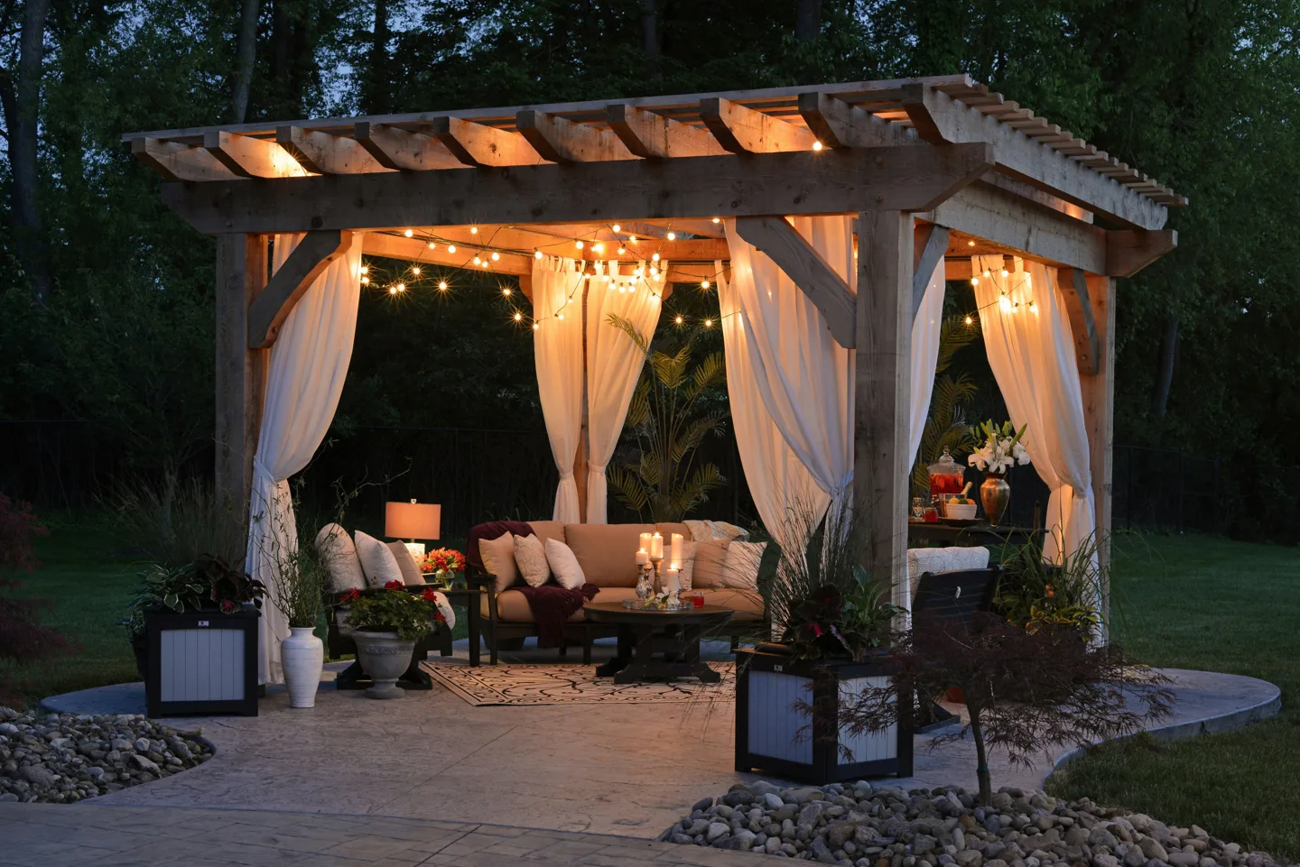 Timber pergola with lighting and seating at dusk