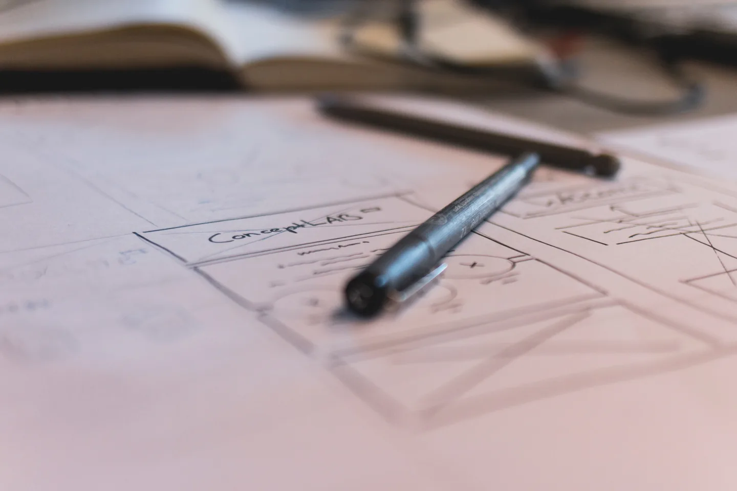 Pen resting on a drawn plan