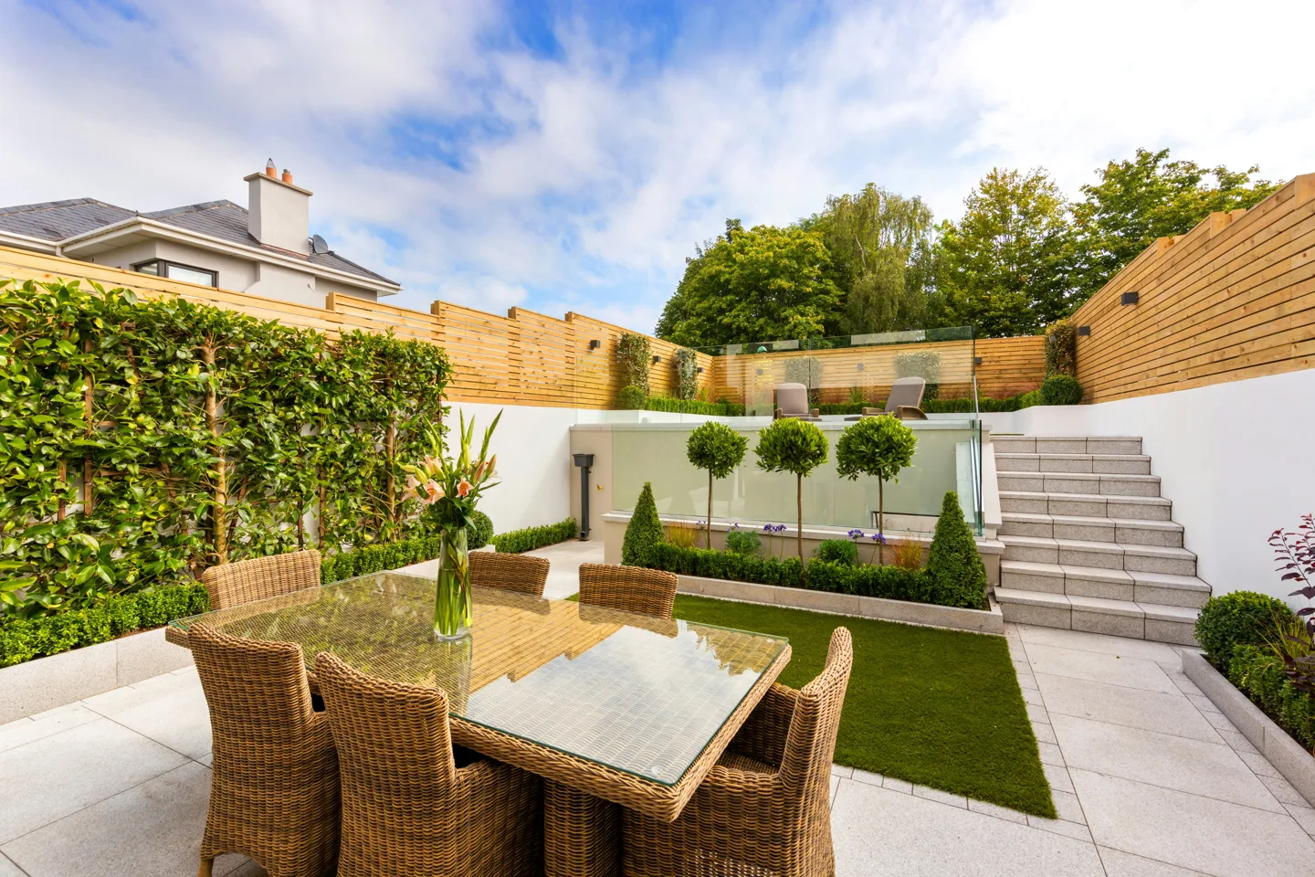 Garden terrace with paving, seating and planted borders