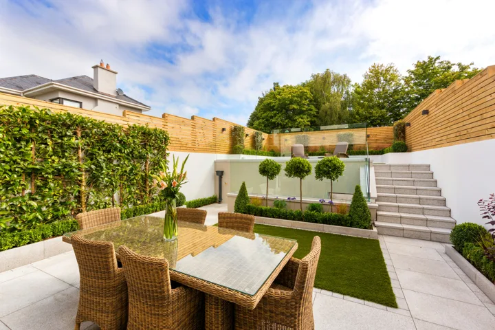 Garden terrace with paving, seating and planted borders