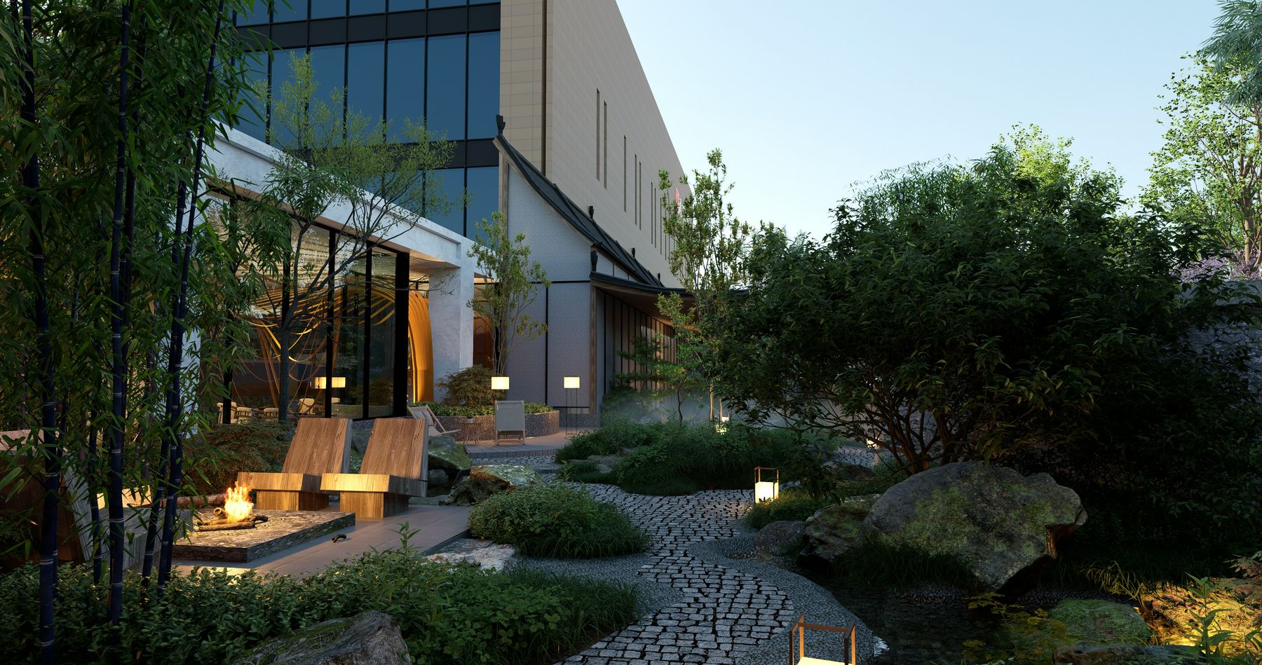 A courtyard garden at dusk with stone path, boulders and warm lighting