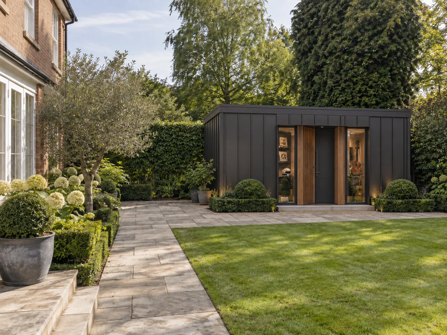 Dark contemporary garden room opening onto a lawn